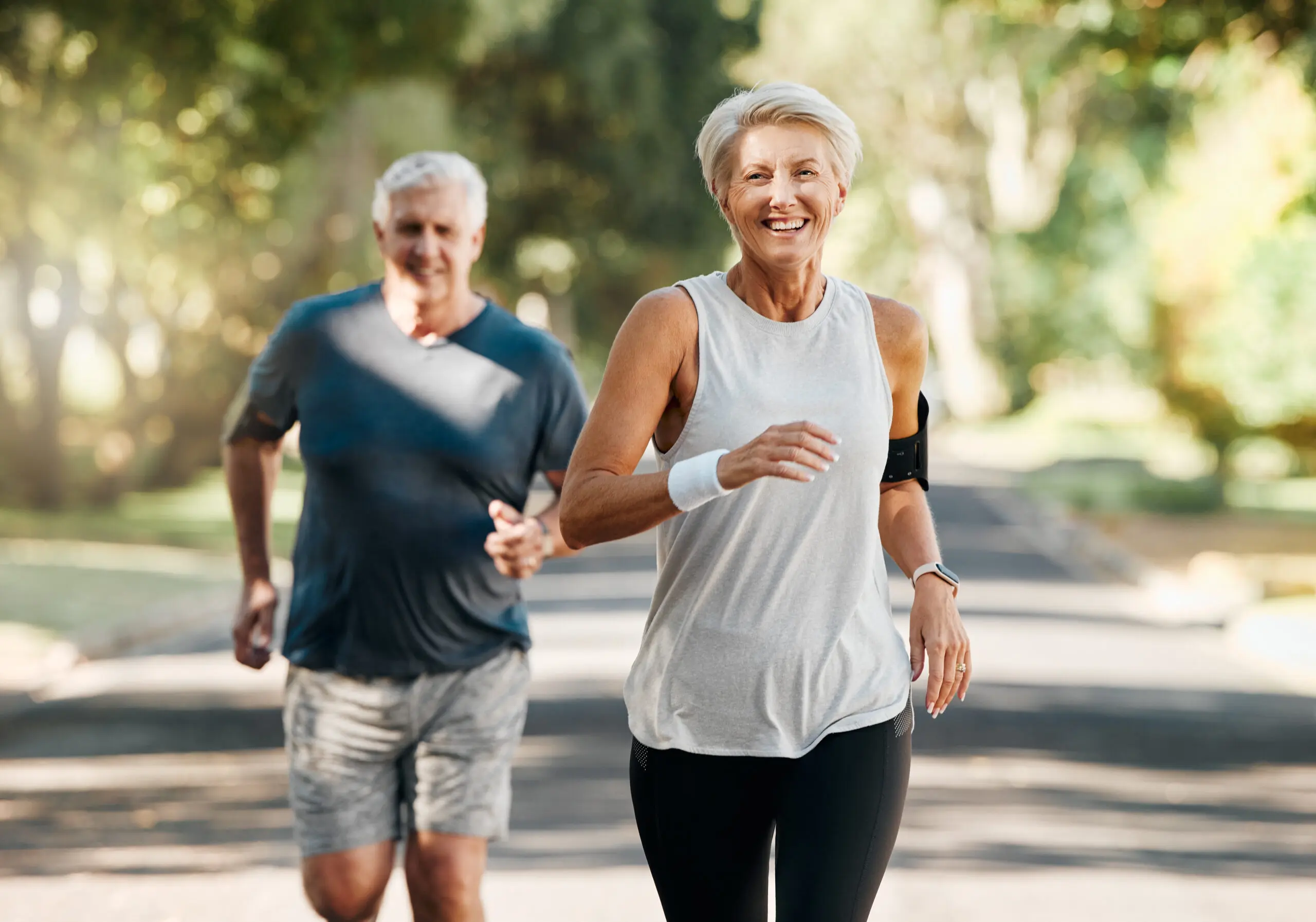 An older couple walking outdoors together in the morning
