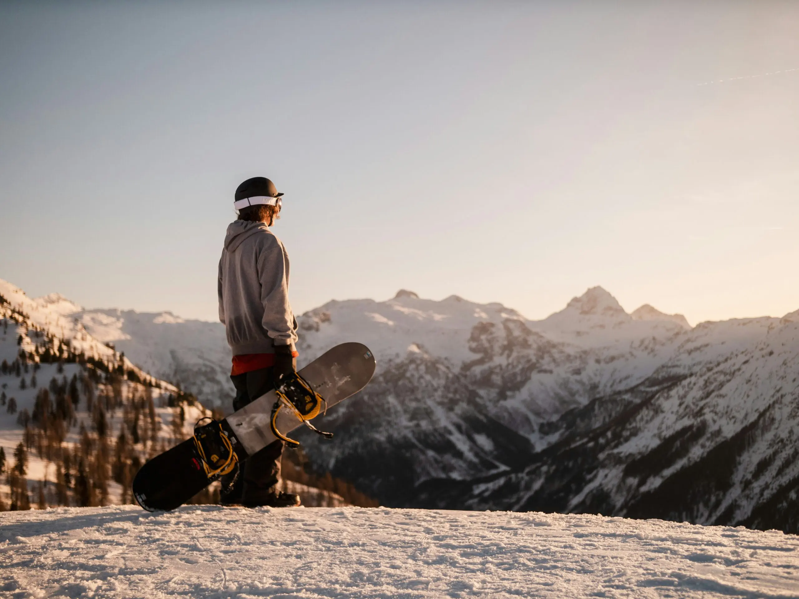 Person on snowboard overlooking mountains